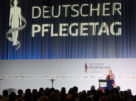 Pflege.Selbstbestimmt Deutscher Pflegetag Bühne mit großem Logo im Hintergrund